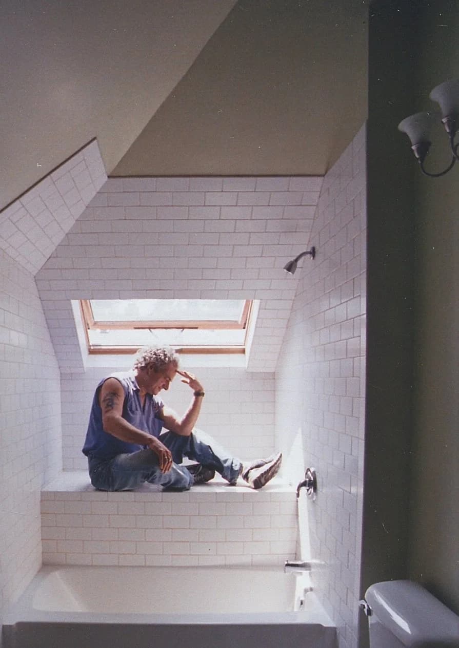 Joseph Weinberg on site in a dormer bathroom he tiled and trimmed by hand